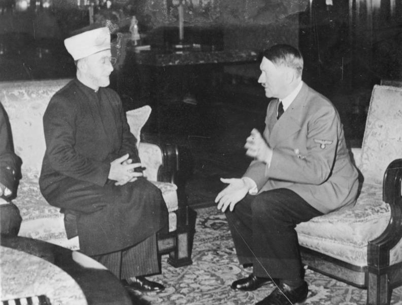 Amin al-Husseini, the Grand Mufti of Jerusalem, seated with Adolf Hitler in Berlin on 28 November 1941.