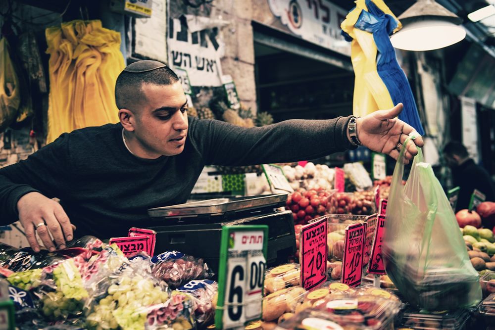 Shoppers at the produce stalls of the Mahane Yehuda market in Jerusalem.