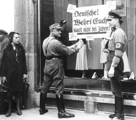 SA men posting anti-Jewish boycott signs on a Jewish shop in Berlin, 1 April 1933.