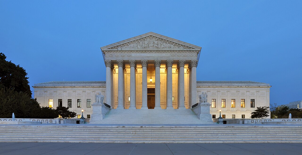 The United States Supreme Court building at dusk, seen from the front steps.